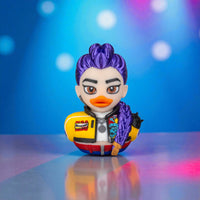 Colorful figurine with purple hair and a yellow jacket on a reflective surface with a blurred colorful background